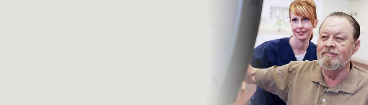 Rehab Therapist with an elderly man in the gym